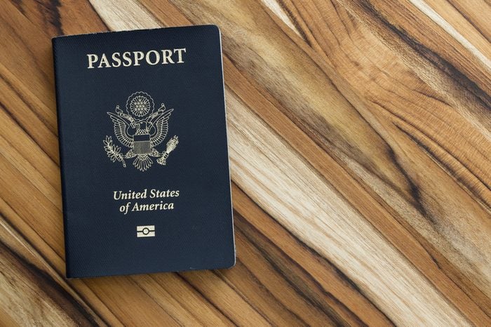 close up of an american passport on a wooden table for a travel concept