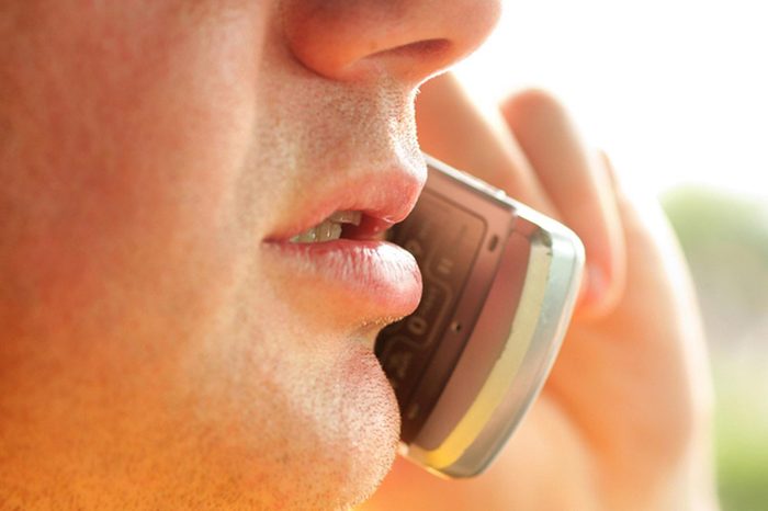 Close-up of man talking on cellular phone