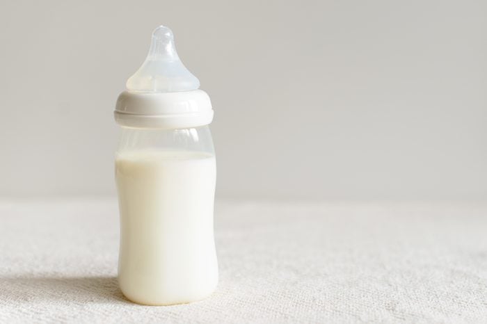 Bottle of milk for baby over blurred background