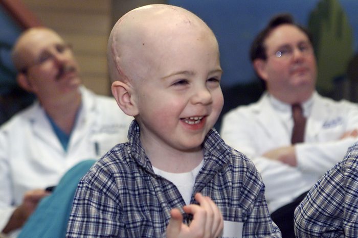 BENTLEY, DUNCAN, TRACY Matthew Bentley, the youngest patient to receive INTRABEAM therapy for a metastatic brain lesion, giggles during a news conference at Hasbro Children's Hospital in Providence, R.I., . Behind Bentley are Dr. John Duncan, left, and Dr. Thomas Tracy, right, two of a team of doctors that removed the tumor from the 4-year-old