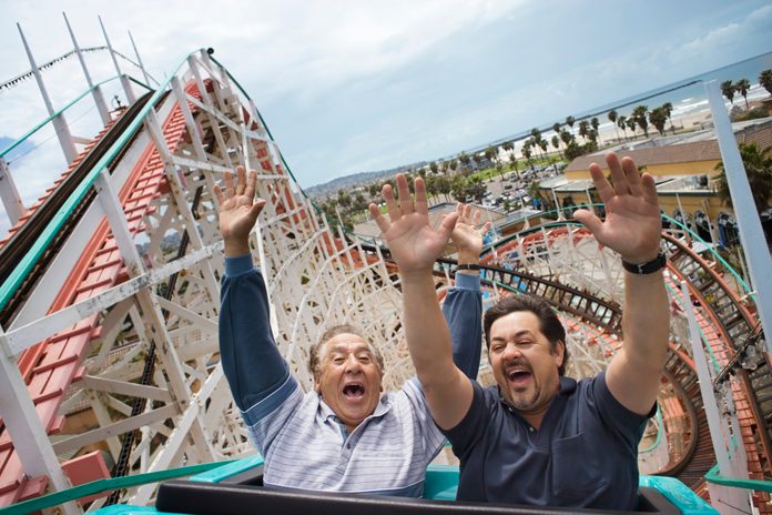 father and son riding roller coaster on Father's Day