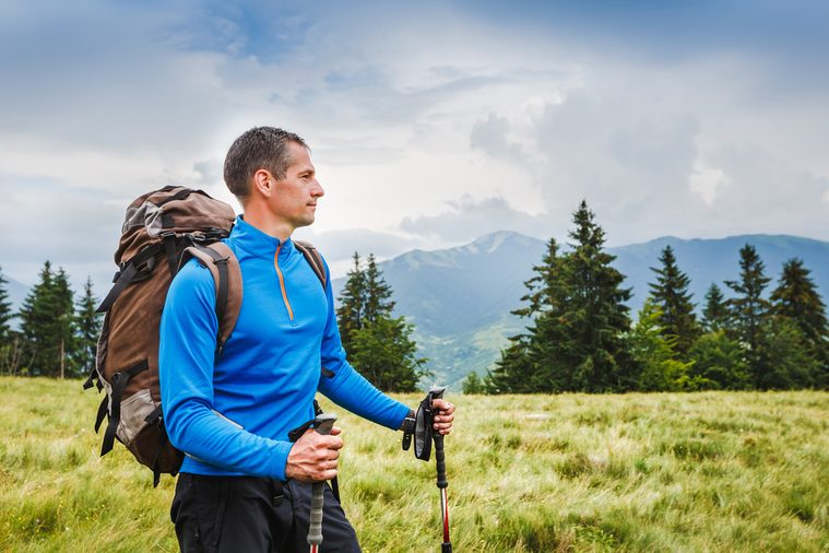 Active healthy man hiking in Alpine mountains