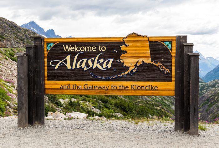 The Welcome to Alaska and the Gateway to the Klondike sign in Alaska, America in the cloudy day