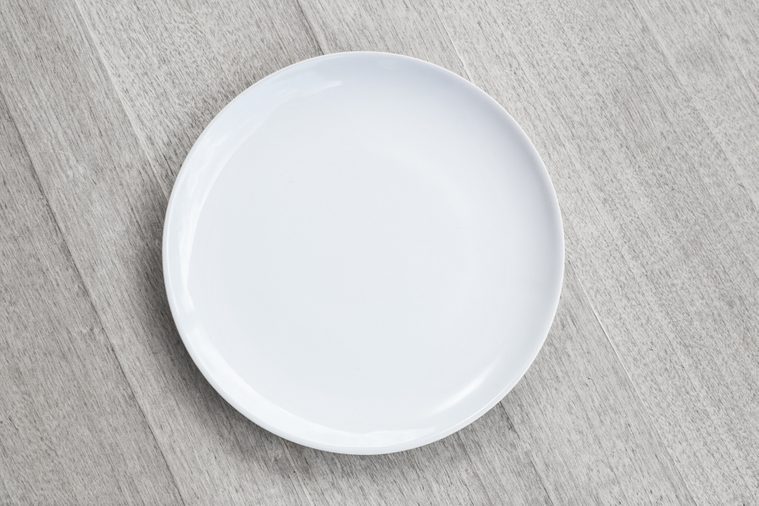 white Empty plate on old wooden background. Top view with copy space