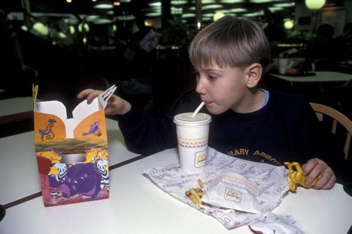 MODEL RELEASED Boy eating McDonalds happy meal UK