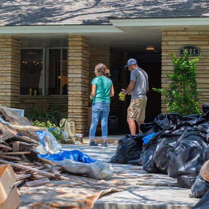 Houston, Texas - August 31, 2017: Cleanup begins in Houston after hurricane Harvey and heavy floods. A family moves belongings from their flooded home in Houston, Texas