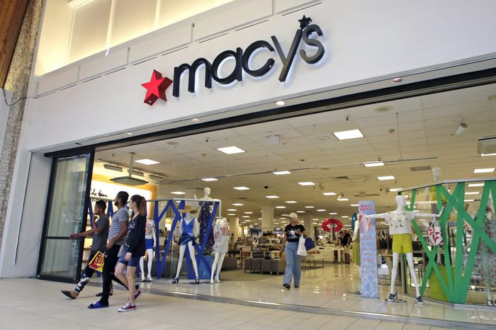 People walk out of a Macy's department store in Hialeah, Fla.