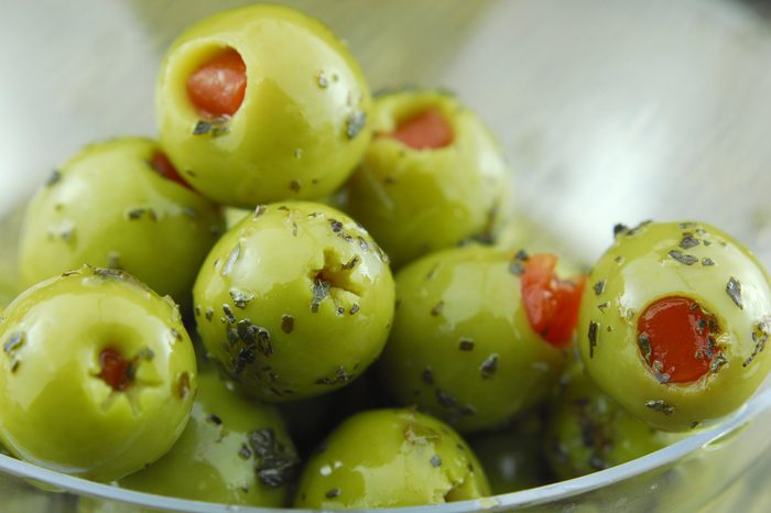 green olive oil stuffed with pimento , spiced with basil and olive oil