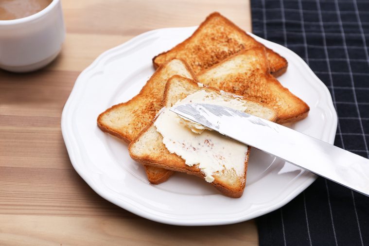 Toasted bread served with butter on plate