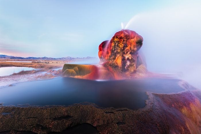Fly Geyser near the Black Rock Desert in Nevada constantly erupts minerals and hot water creating bright colors and terraced pools.