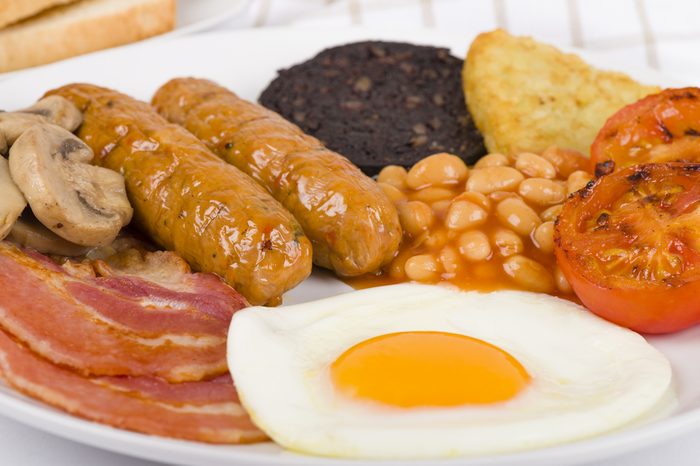 Full English Breakfast - Traditional English fry-up with egg, bacon, mushrooms, tomatoes, sausages, black pudding, hash browns and baked beans. Served with slices of toast.