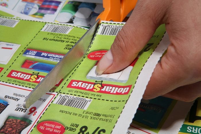 A woman cutting coupons