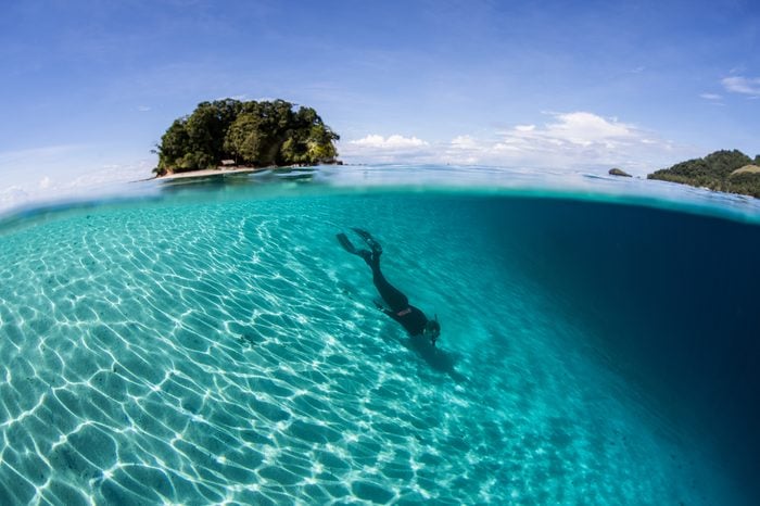 A snorkeler does some free diving along a sandy slope in the Solomon Islands. This country offers incredibly diverse marine habitats, great scuba diving, and fantastic snorkeling.