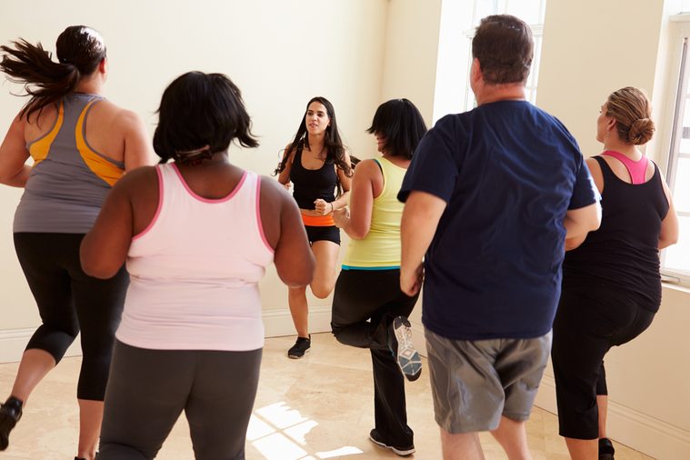 Fitness Instructor In Exercise Class For Overweight People