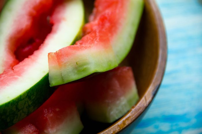 eaten slice of watermelon. Watermelon Rind. watermelon rind cut in piece on black plate