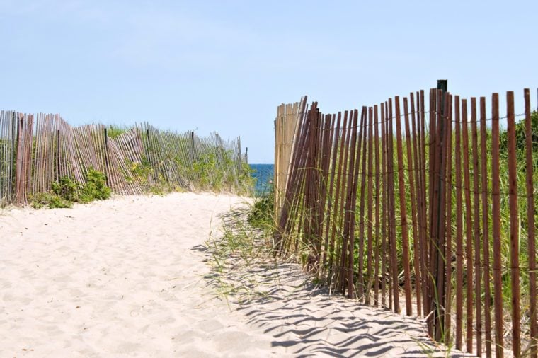 Wooden fences lining the entrance to the Rhode Island beach.