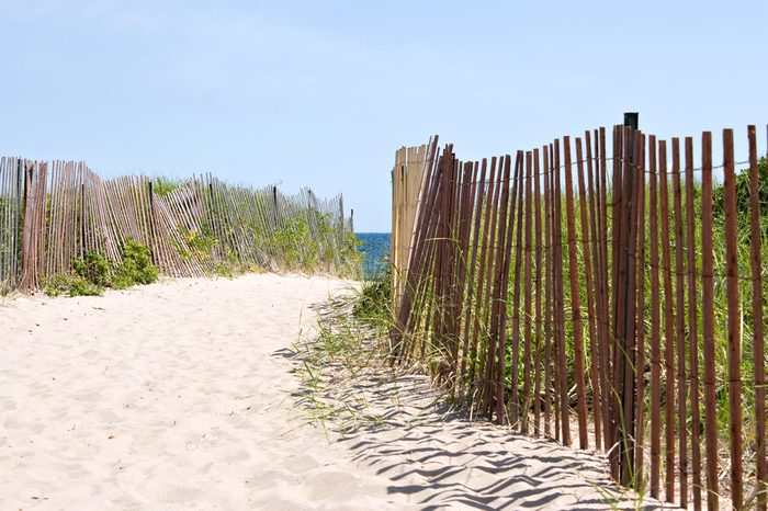 Wooden fences lining the entrance to the Rhode Island beach.