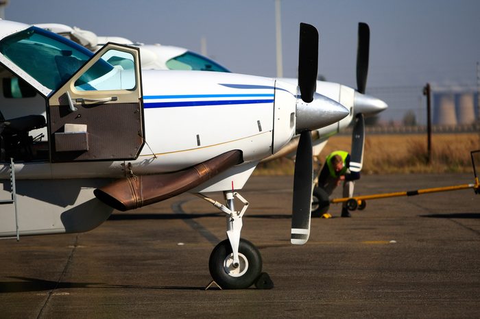 Two light aircraft standing next to each other on the runway