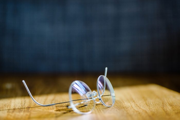 Elegant modern eyeglasses spectacles with thin titanium rim on office table