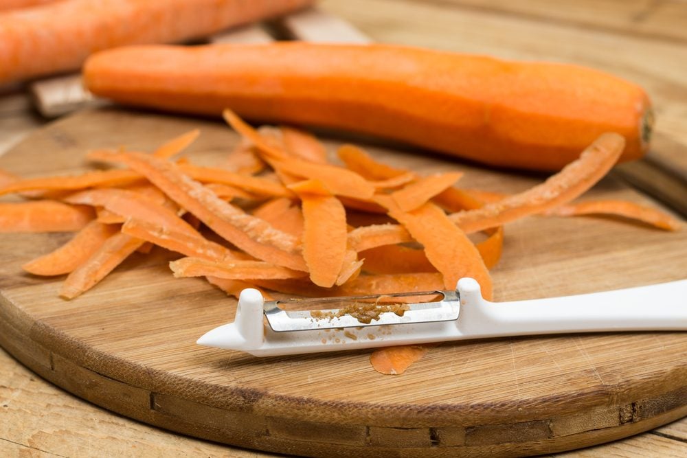 Peeled fresh raw carrots on the cutting board.