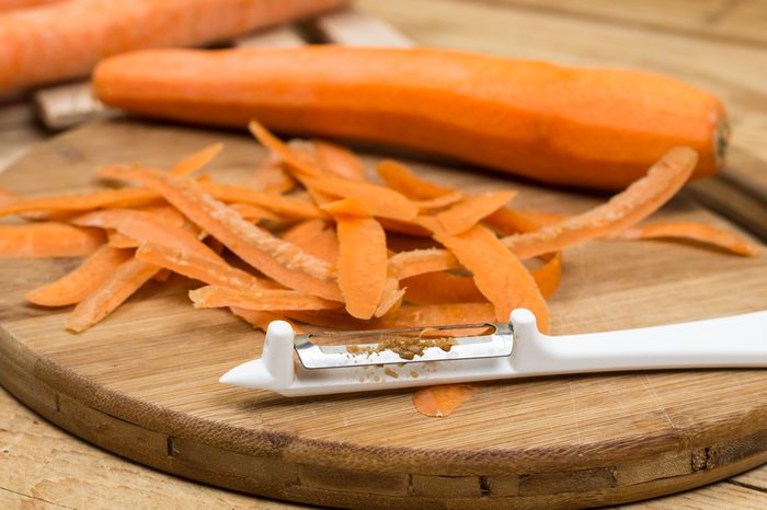 Peeled fresh raw carrots on the cutting board.