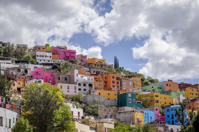 View of the colorful city of Guanajuato in Mexico. Every house is painted to different bright color giving a very cheerful atmosphere to the city. Captured on a sunny cloudy day.