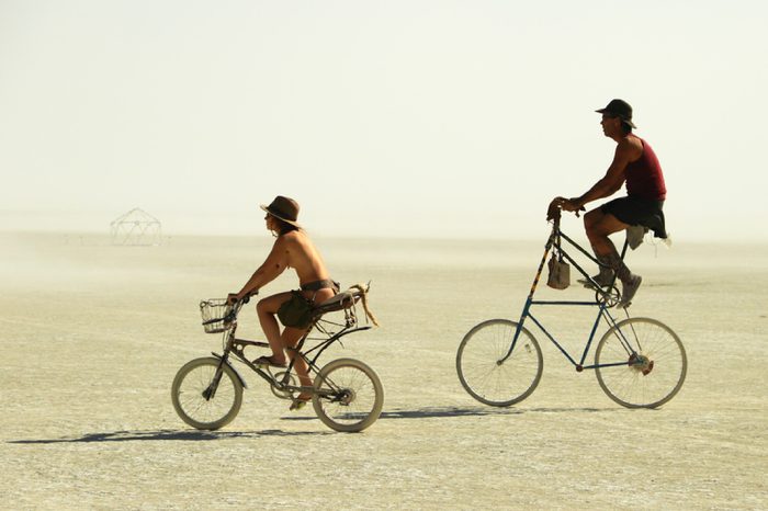 BLACK ROCK CITY, NEVADA - SEPTEMBER 4: Unidentified couple ride on unique bicycles at the Burning Man festival on September 4, 2011 in Black Rock City, Nevada, USA.