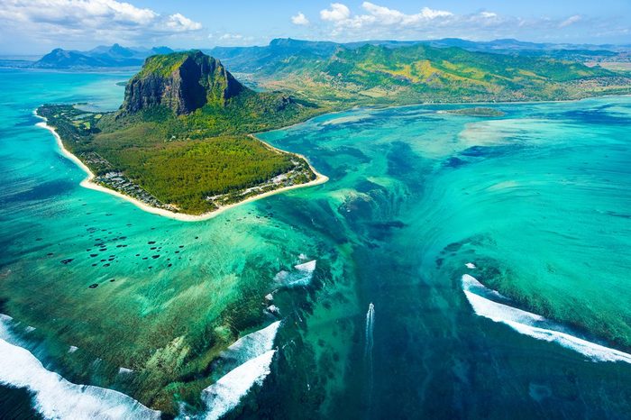 Aerial view of Mauritius island panorama and famous Le Morne Brabant mountain, beautiful blue lagoon and underwater waterfall
