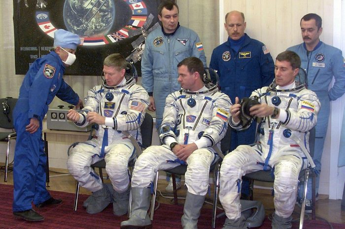 Baikonur Kazakhstan: Commander of the First Long-duration Mission to the International Space Station American Astronaut Bill Shepherd (l) Russian Cosmonauts Yuri Gidzenko (c) and Sergei Krikalev (r) Check the Space Suits As the Back Up Pilots and the Members of the 3-rd Mission at the Same Time Mikhail Tiurin (up L) American Astronaut Kenneth Bauersocks (up C) and Vladimir Dezhurov (up L) Look on Before Thestart the First Long-duration Mission to the International Space Station 31 October 2000