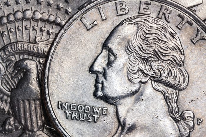 Close-up detail on a United States quarter dollar coin - In God we Trust - Liberty.