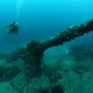 Shipwreck of the Torpedo boat Giuseppe Dezza and scuba diver underwater in the Mediterranean Sea 