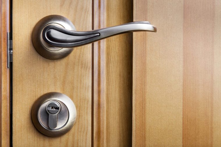 Modern style door handle on natural wooden door