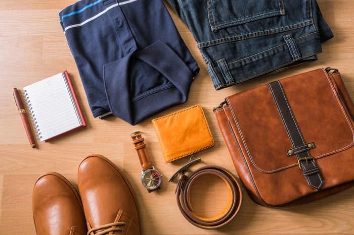 flat lay of men's casual fashion on white wooden floor