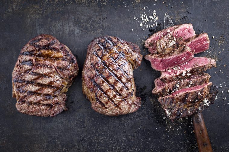 Barbecue Entrecote Steaks on old Metall Sheet