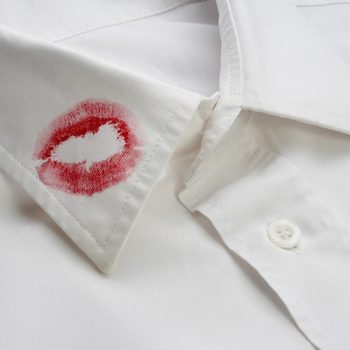 close up of white shirt and red lipstick on it