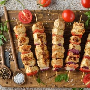 Kebabs with turkey fillet on a brown background
