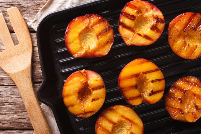 Ripe peaches on a a grill pan on a table close-up. Horizontal view from above