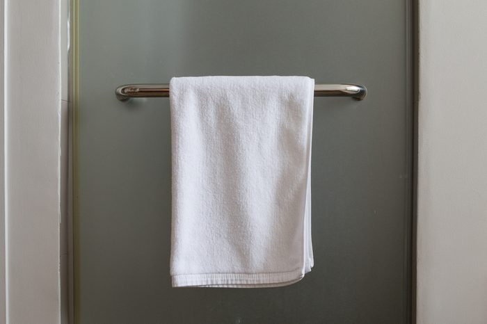 Towel hanging at mirror door in the bathroom.