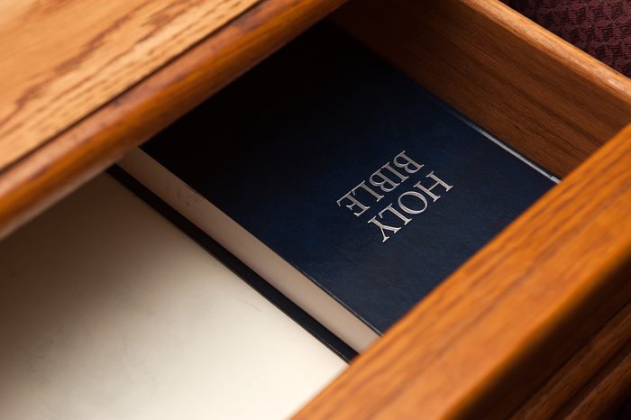 Holy Bible book lying in a open drawer. selective focus on a holy bible sign