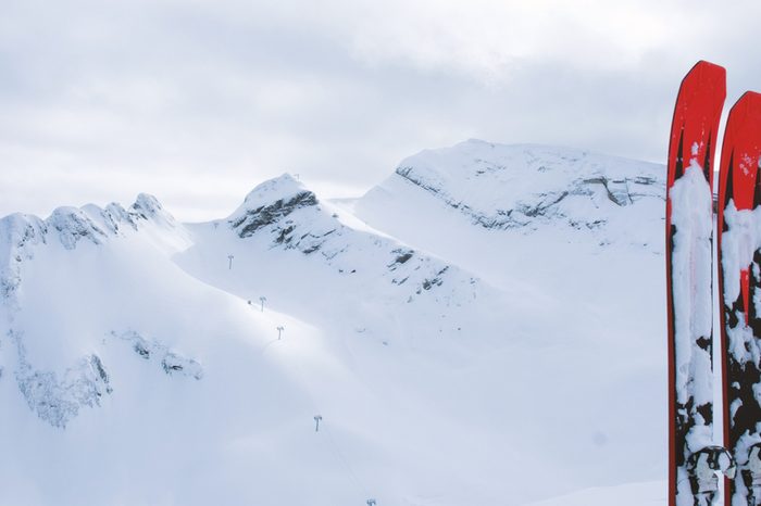 Mountain skiing are on the background of snowy mountains, 4K.