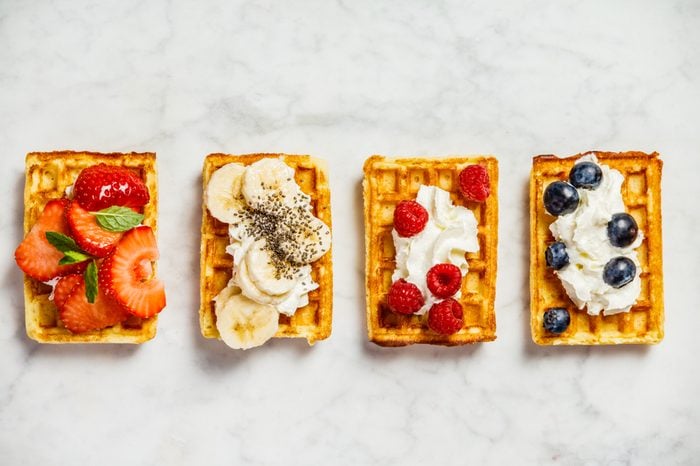 Traditional belgian waffles with whipped cream and fresh fruits 