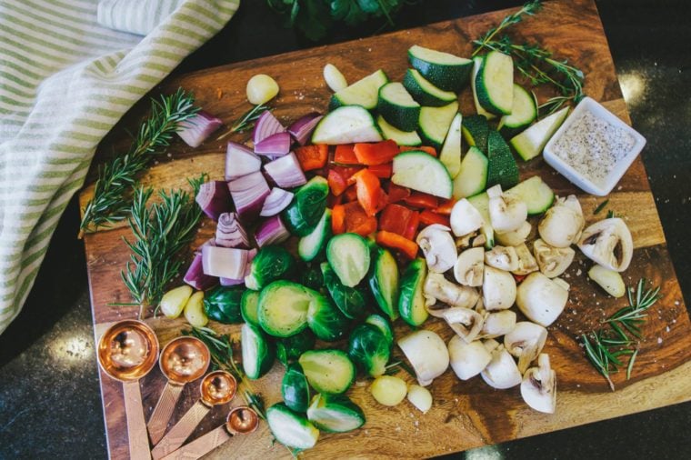 Chopped vegetable medley on wooden cutting board