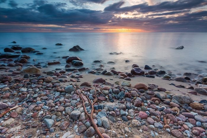 Beautiful long exposure landscape of rocky sea shore. Tranquil scene of Baltic sea.