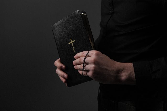 The Bible with the Cross in the Hands of the Priests