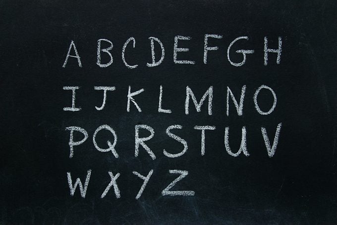 Alphabet letters written in chalk on blackboard