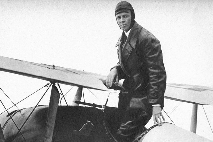 Charles Lindbergh (1902 - 1974) in his flying kit standing in 'Spirit of St Louis', the plane in which he made the first non - stop Atlantic air crossing: 20 - 21 May 1927. Landed at Le Bourget Airdrome, Paris, after a flight of 33.5 hours