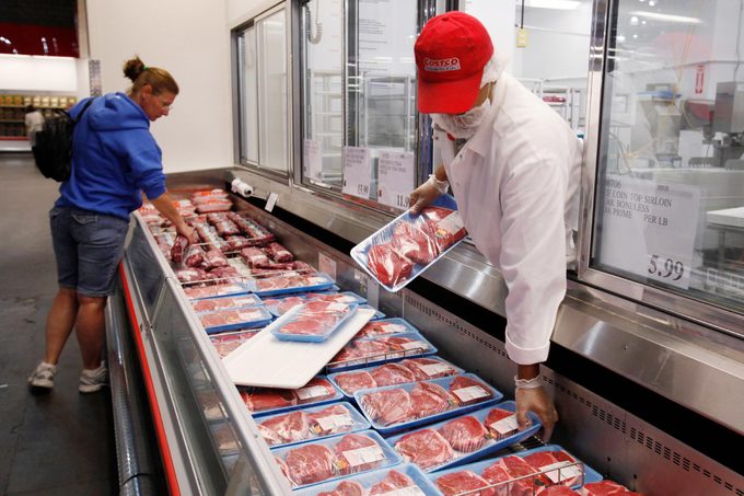 A Costco butcher puts out beef at Costco in Mountain View, Calif. Wholesale prices rose last month for the second straight month as the cost of energy climbed enough to offset an unexpected drop in food prices