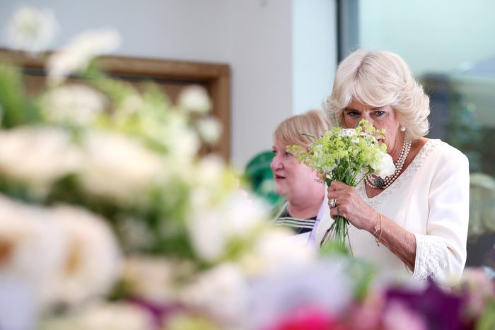 Camilla Duchess of Cornwall helps to create a bouquet with volunteers from Floral Angels during a visit to the Garden Museum to view a British Flowers Week exhibition