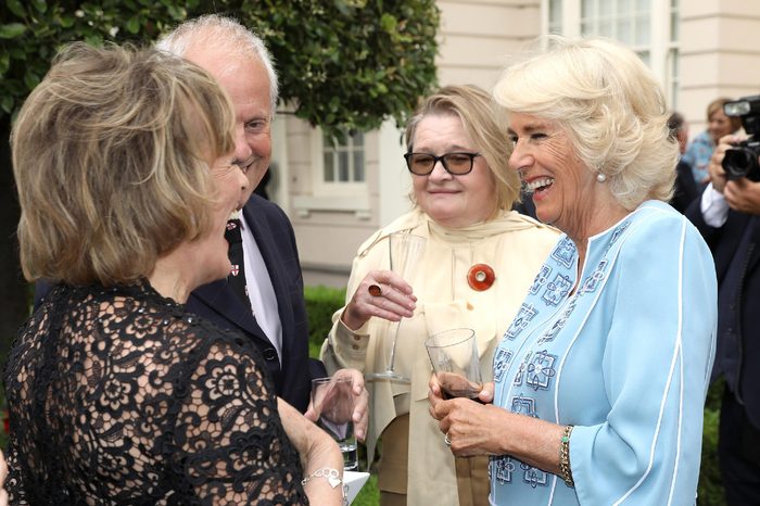 Camilla Duchess of Cornwall talking to Esther Rantzen (l) and Gyles Brandreth and guest at a reception to mark her 70th birthday at Clarence House