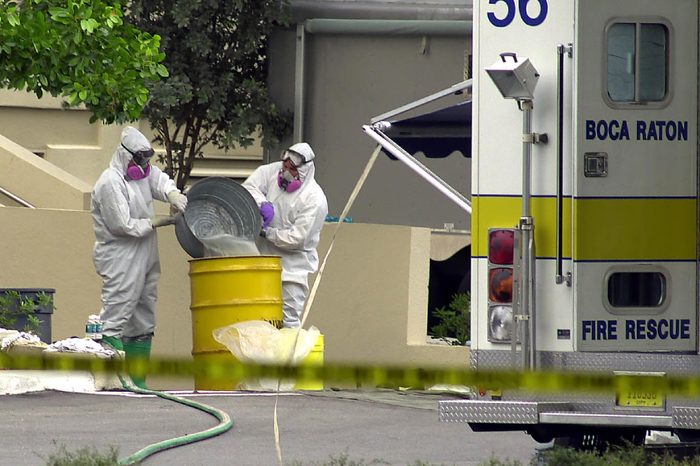 FBI FBI agents wearing bio hazard suits pour liquid into a yellow drum outside the American Media Inc. building in Boca Raton, Fla., . FBI and local law enforcement closed building which houses the offices of several supermarket tabloids. The Anthrax virus was found in an employee's nose and on a computer keyboard Monday, Oct. 8, 2001, after a photo editor for the company died Friday of the rare disease. All 300 people who work in the building and anyone who spent more than an hour inside since Aug. 1 were advised to visit health officials